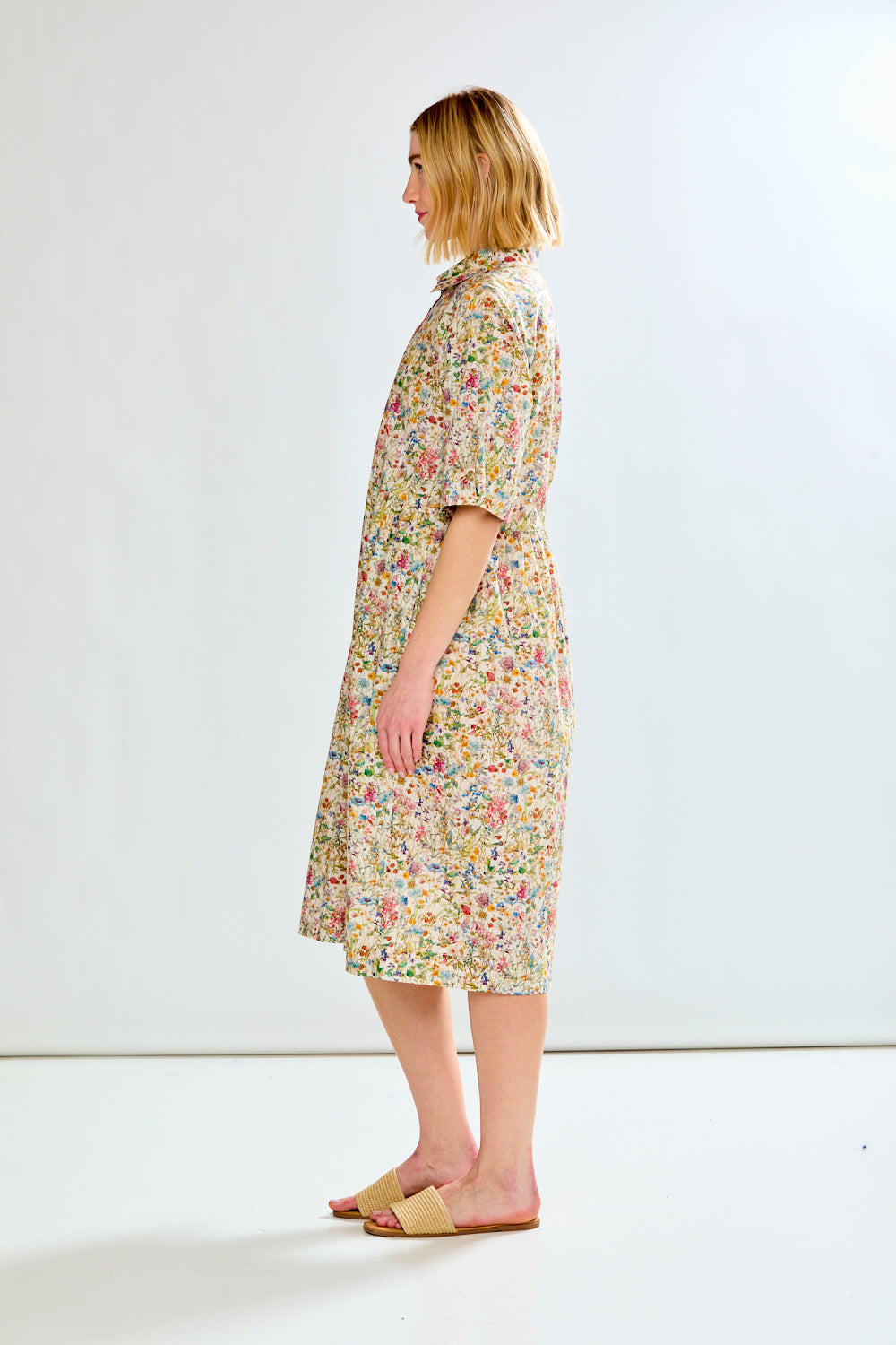 Woman wearing a floral dress on a white background
