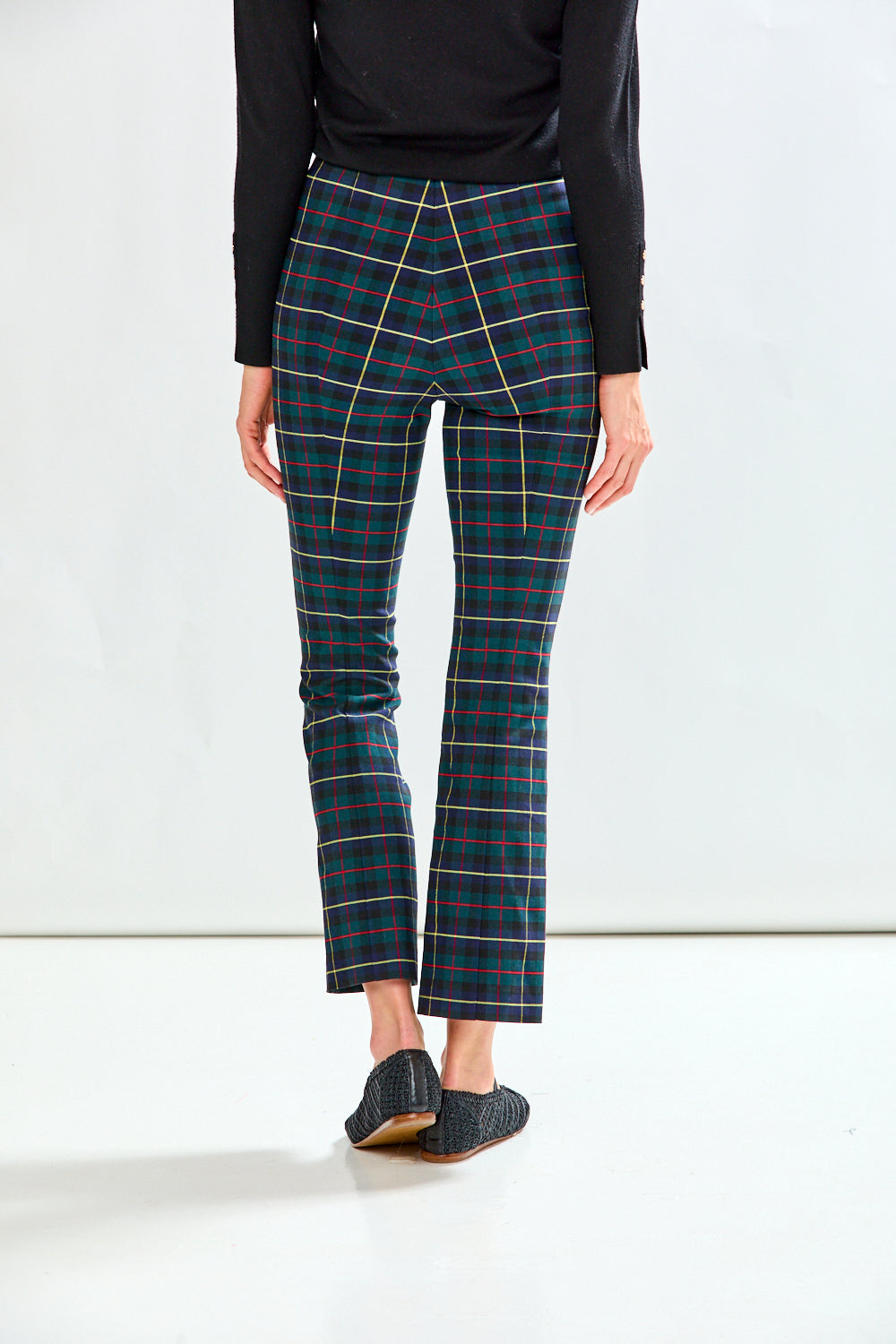 Woman wearing plaid pants on a white background