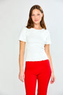 woman in white top and red pants