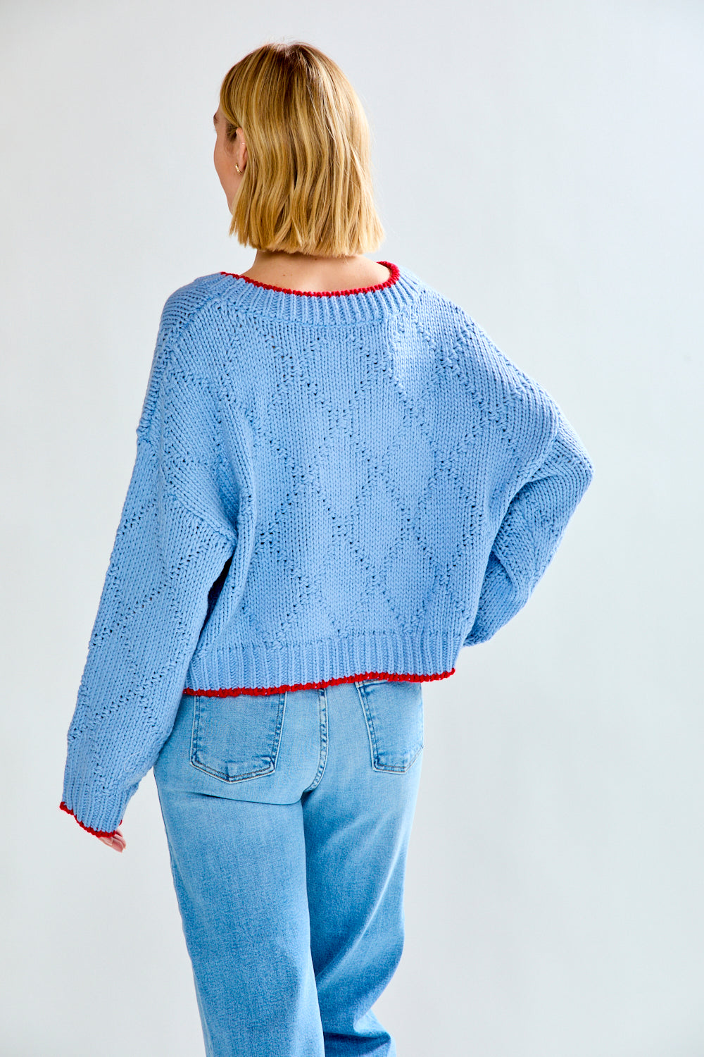 Woman with blue fish sweater on