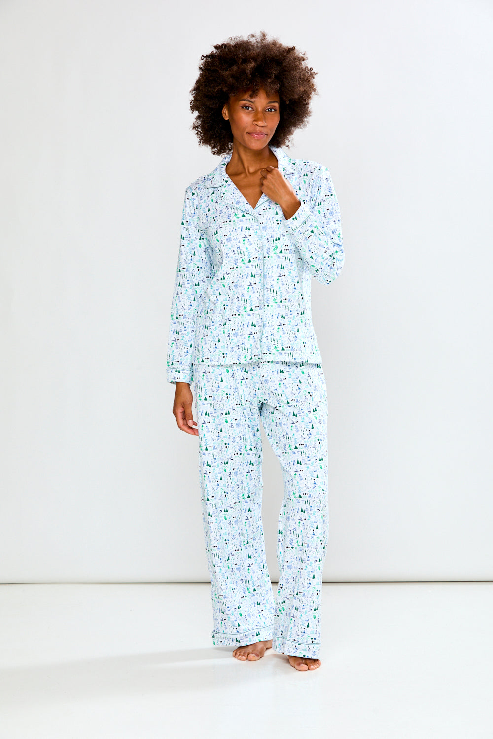 Woman wearing a light blue pajama set on a white background