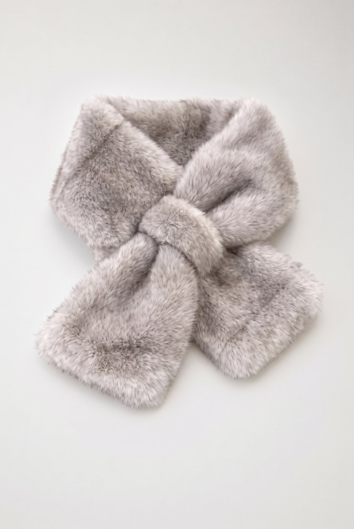 A light gray faux fur scarf tied in a bow, displayed on a clean white background.
