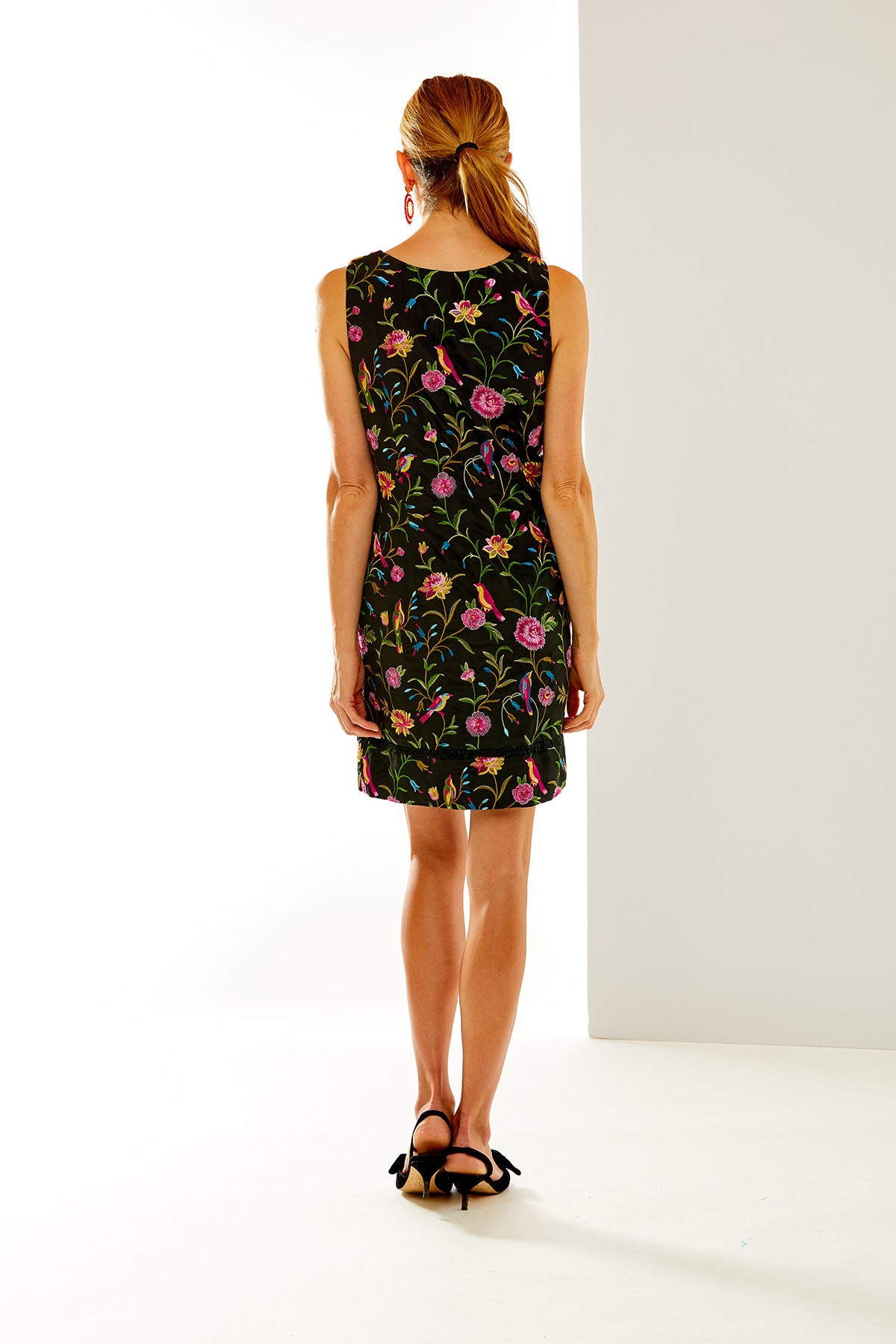 Woman in floral embroidered shift dress
