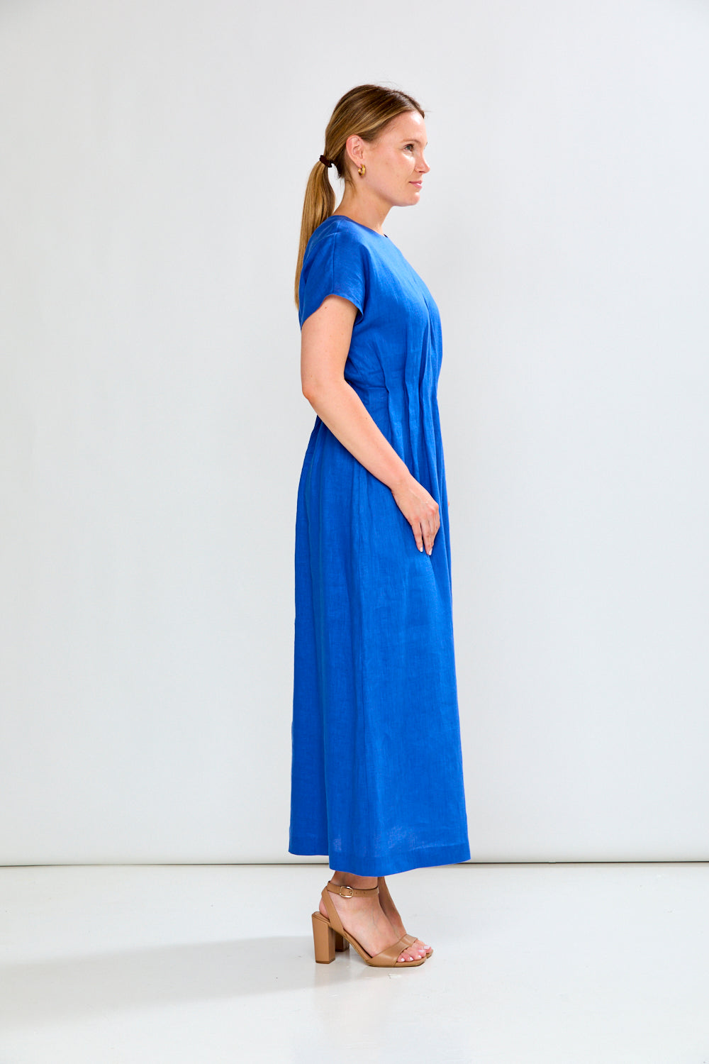 Woman wearing a blue dress against a white background