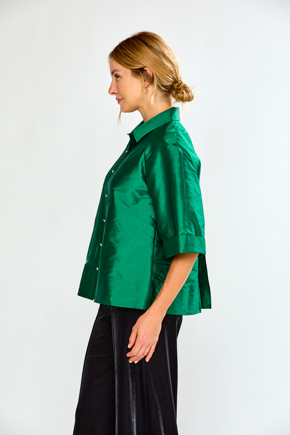 Woman wearing a green shirt with a collar on a white background