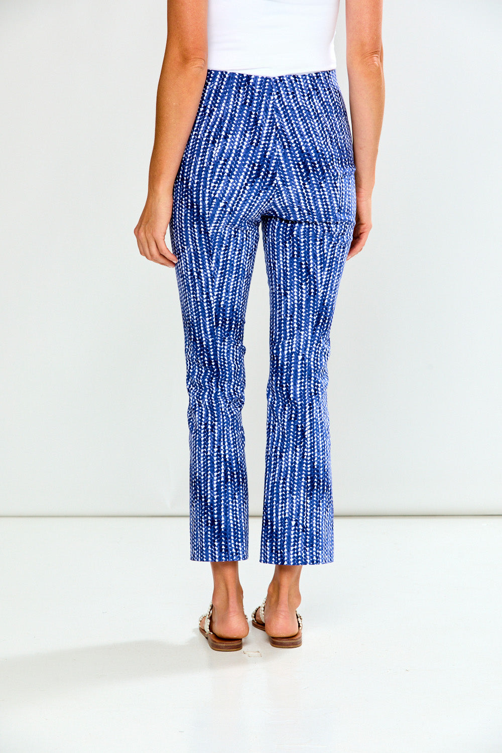Woman wearing blue and white patterned pants on a white background