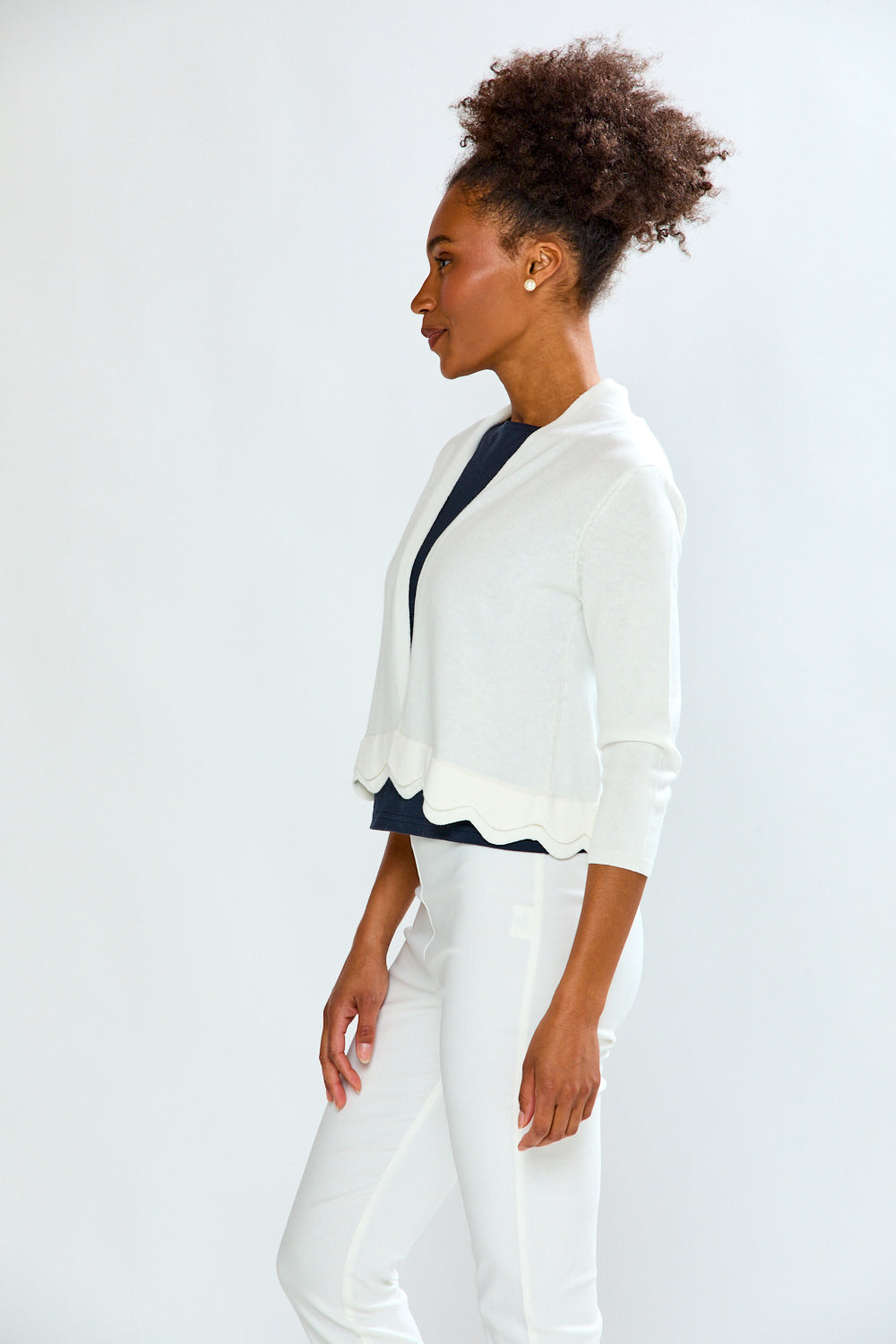 woman in white scalloped sweater