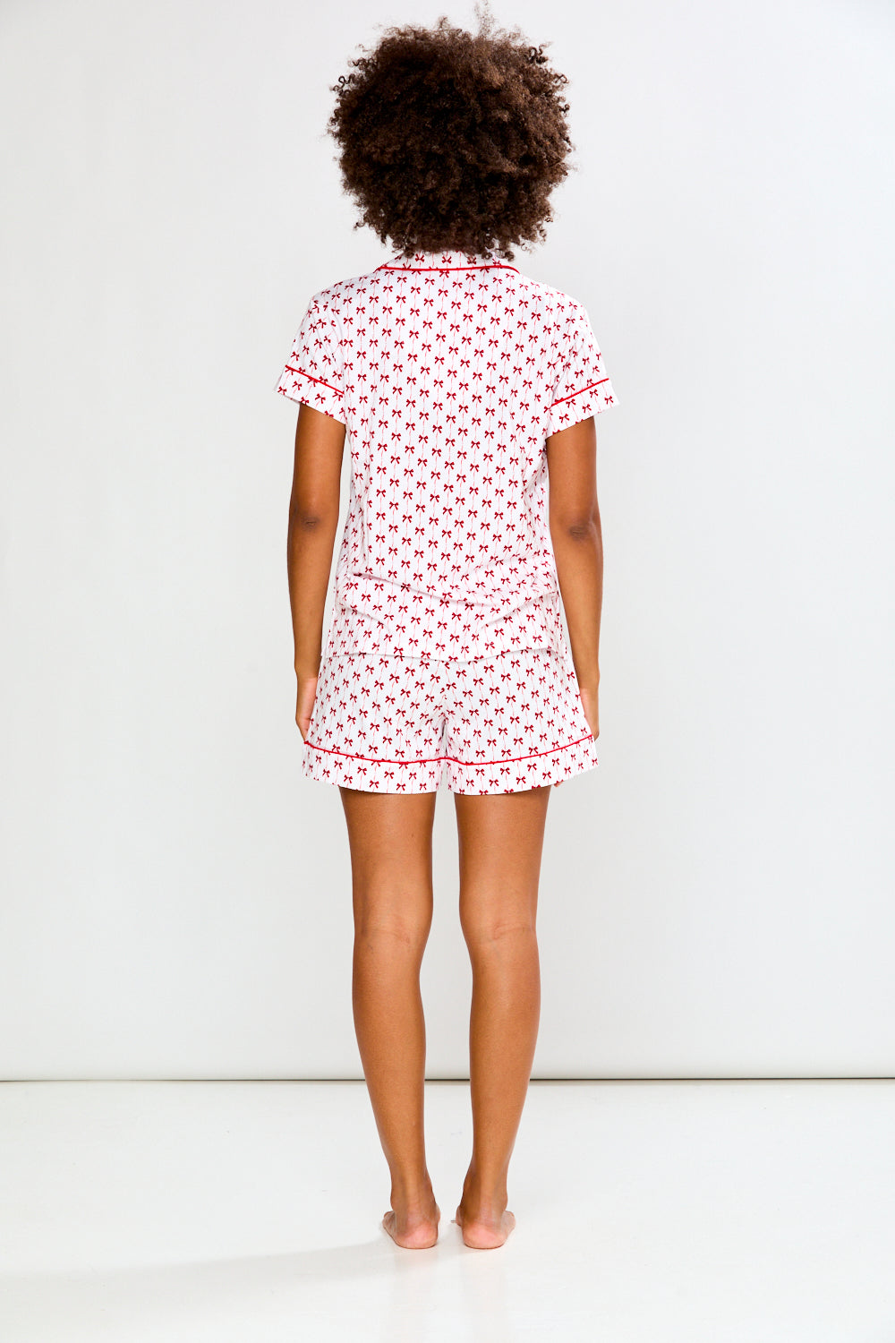 Woman in bow printed pajamas