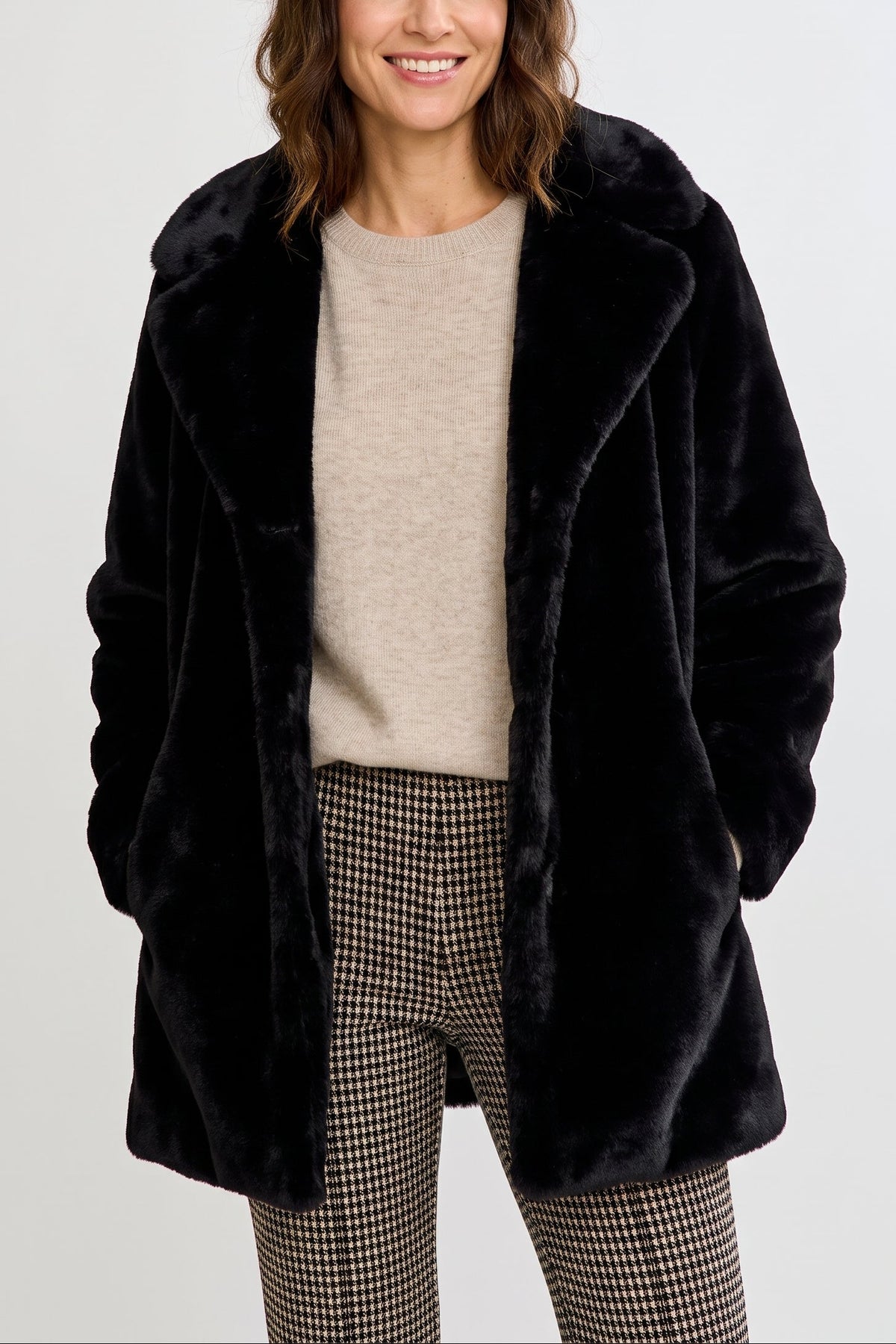 Woman wearing a black faux fur jacket