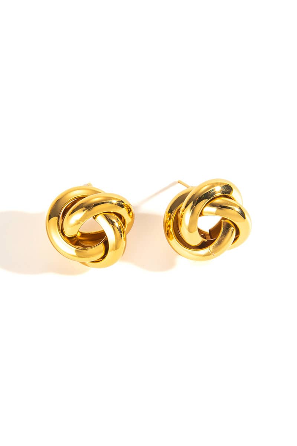 Gold knot earrings on a white background
