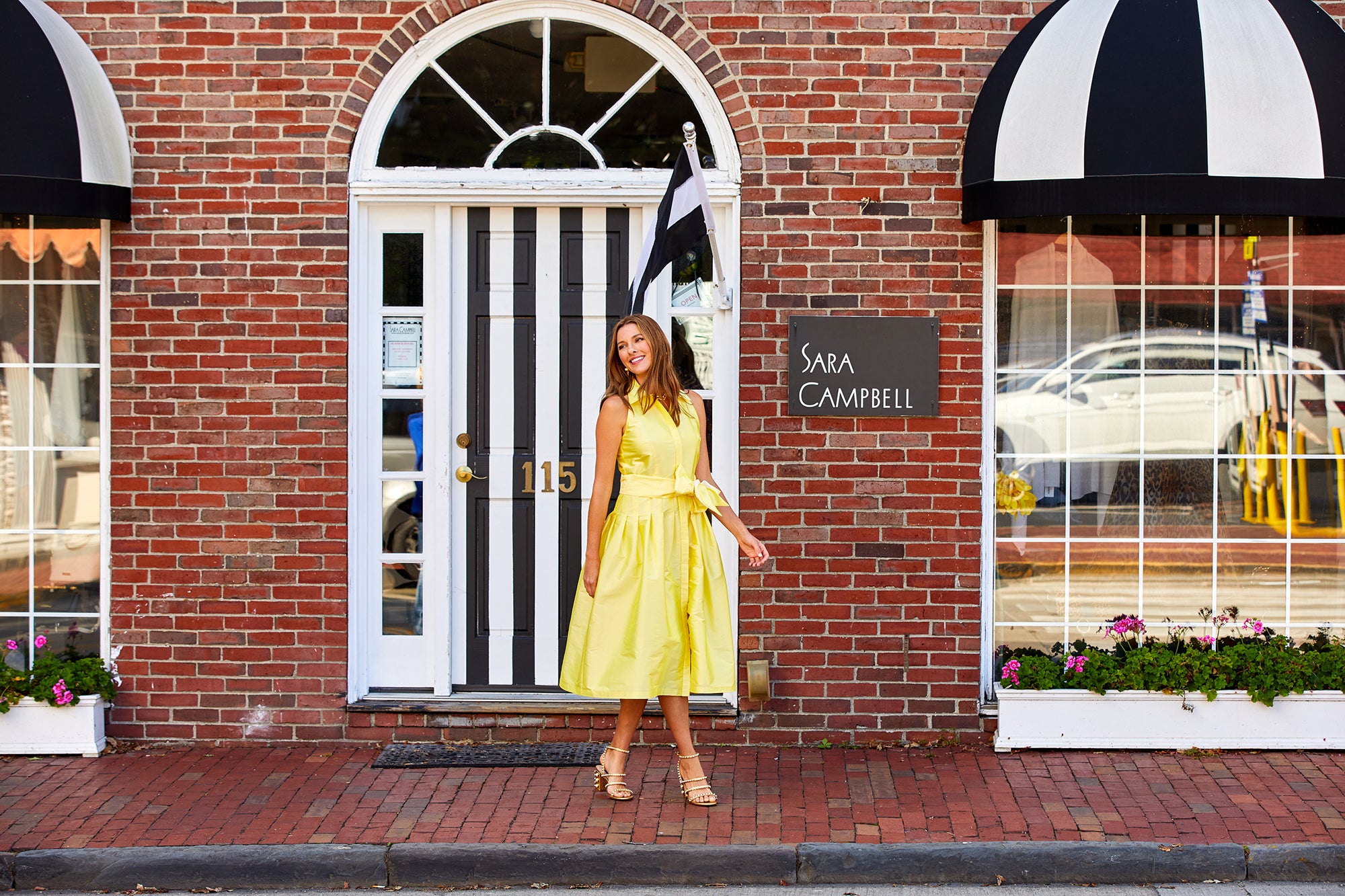 Woman walking in front of a Sara Campbell store