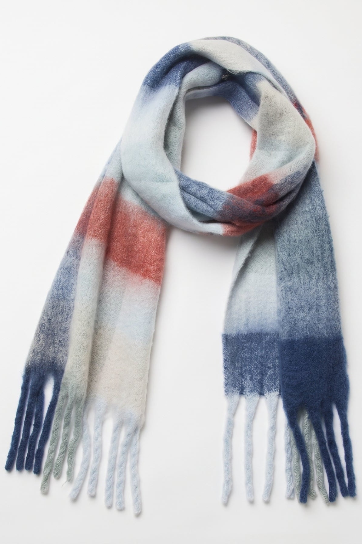 A soft, fuzzy scarf with a plaid pattern in shades of blue, navy, white, and muted red, finished with fringed ends, displayed on a clean white background.
