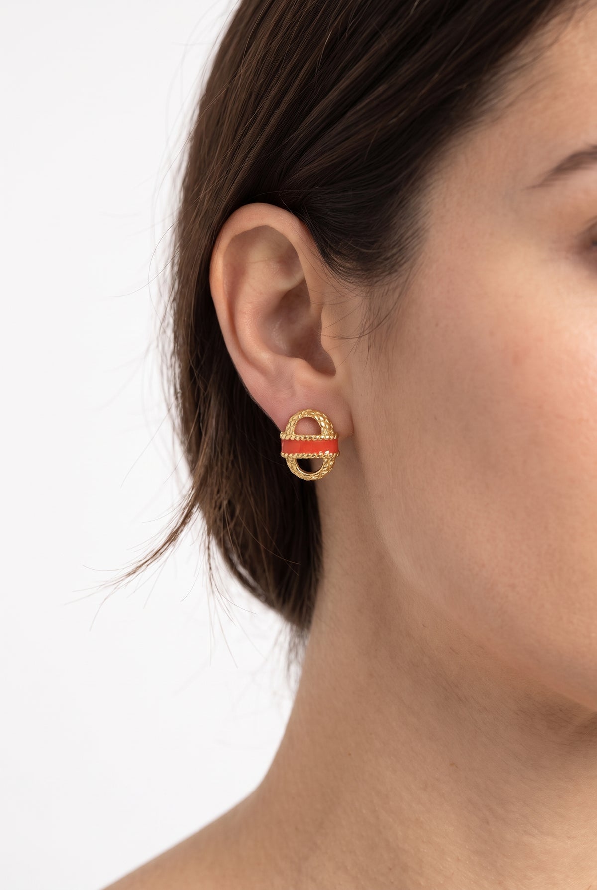 Woman wearing gold and orange basket stud earrings