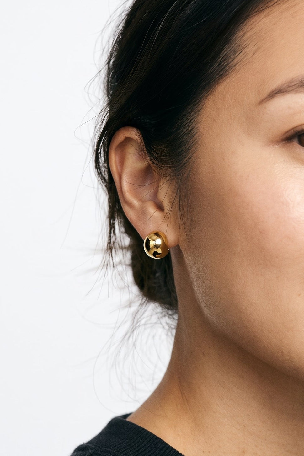 Woman wearing the Polished Dome clip on earrings