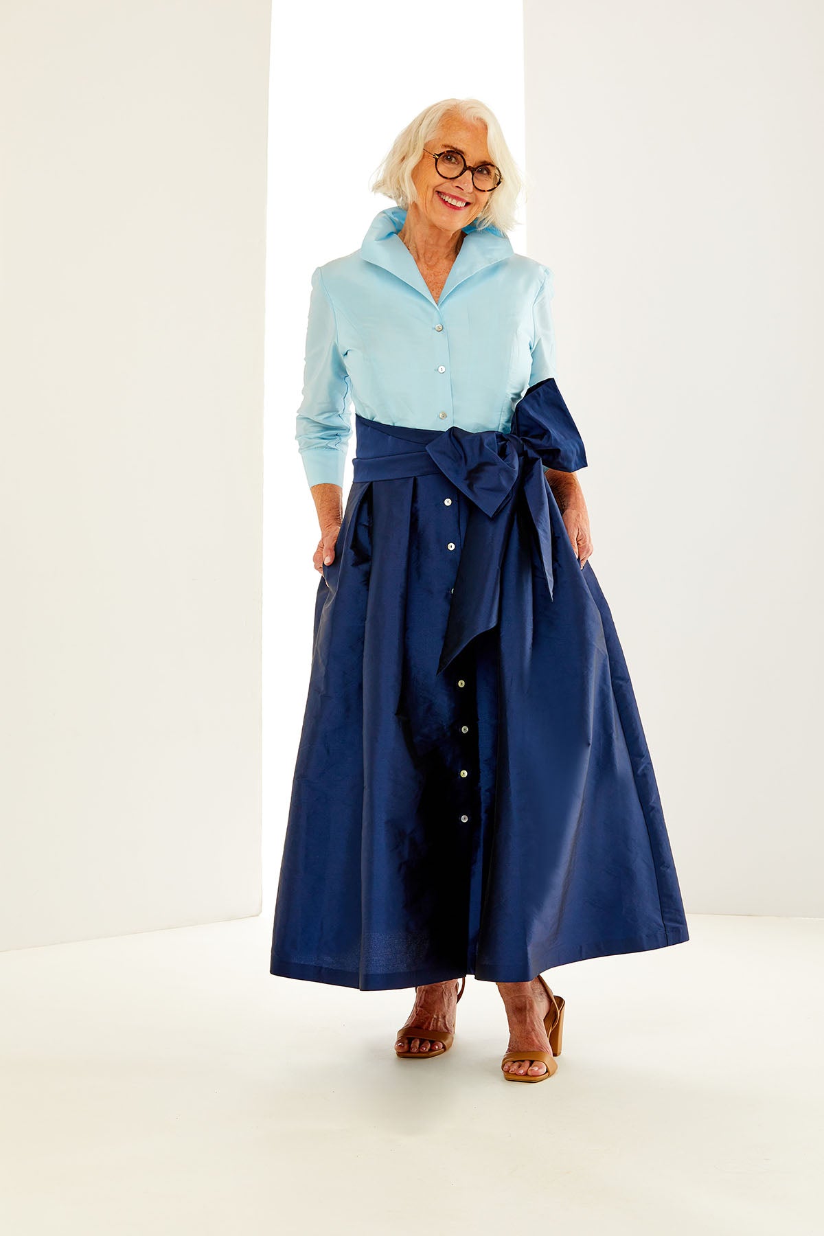 Woman in light blue/navy dress