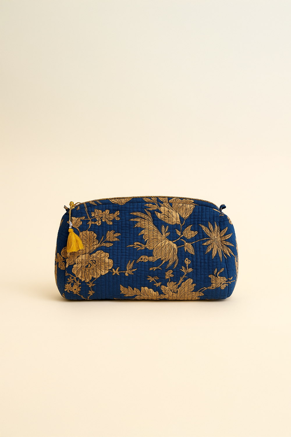 Blue pouch with gold floral patterns on a beige background