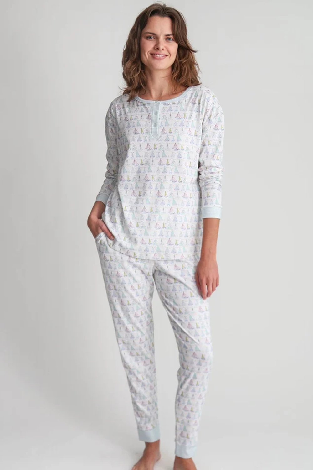 The Holiday Sailboat Long Pajama Set in 100% Pima cotton with pastel sailboat print long sleeve top and matching pants modeled by a woman