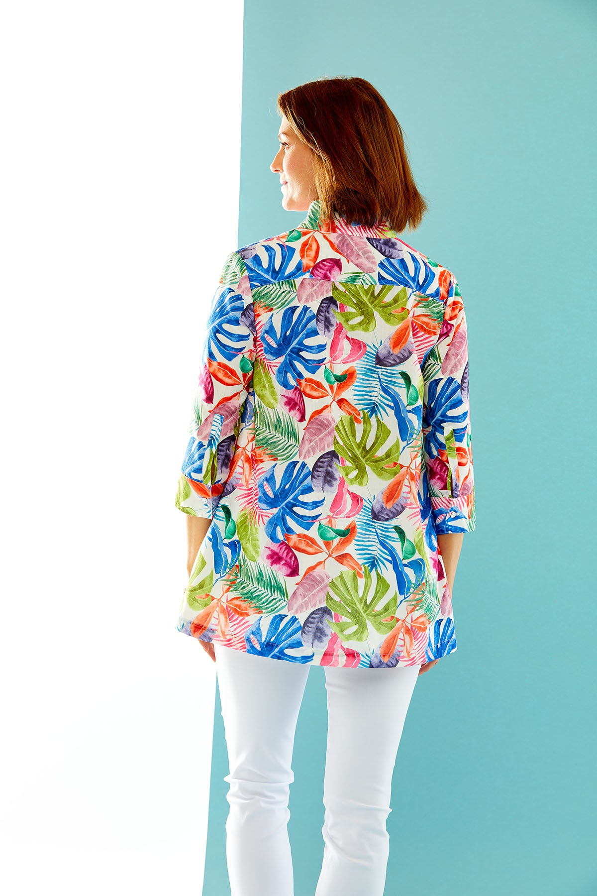 woman in multi-color palm print button down tunic