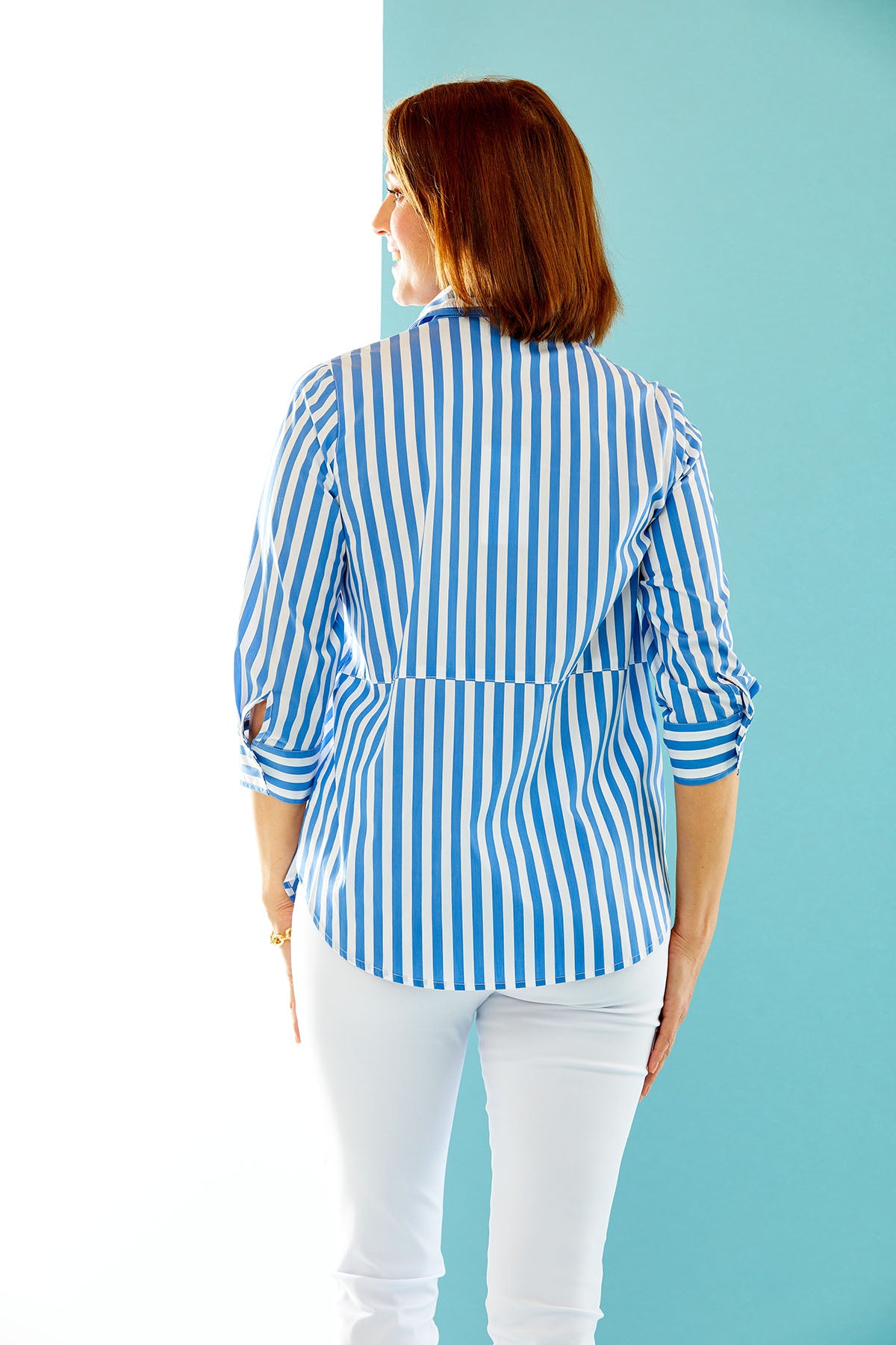 woman wearing ocean blue & white striped button down with front pocket