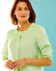Woman in citrus blouse