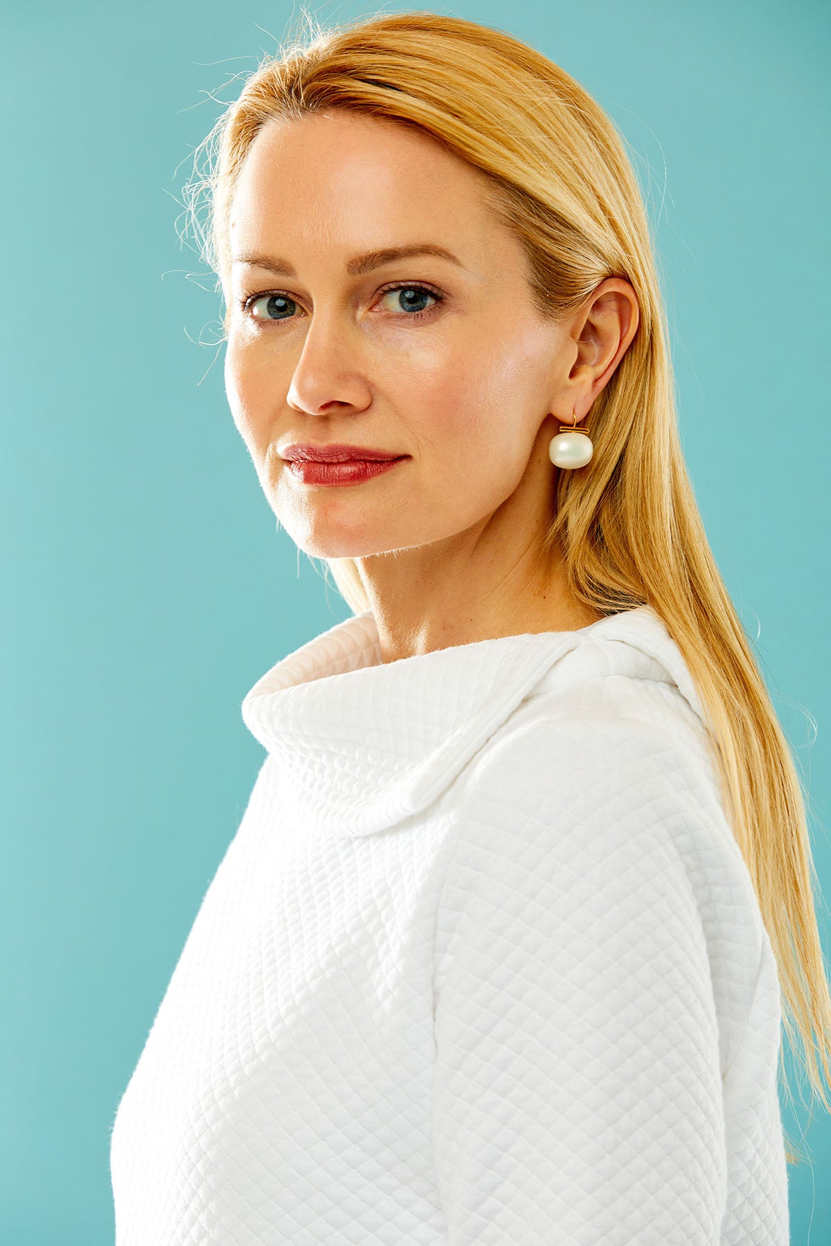 woman in white pullover with asymmetrical collar