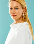 woman in white pullover with asymmetrical collar