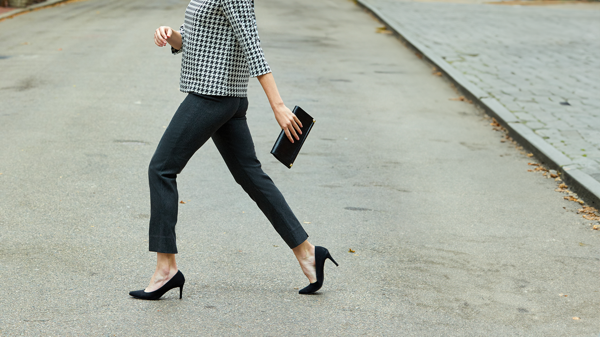 Woman walking across the street wearing Sheri Pants