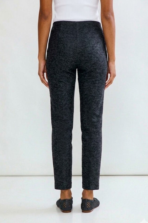 Person wearing dark gray pants on a white background