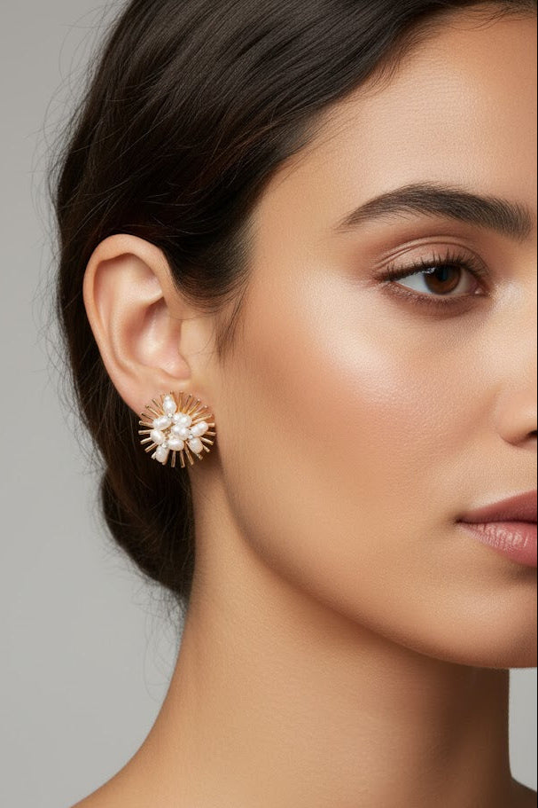 Woman wearing gold sunburst earrings