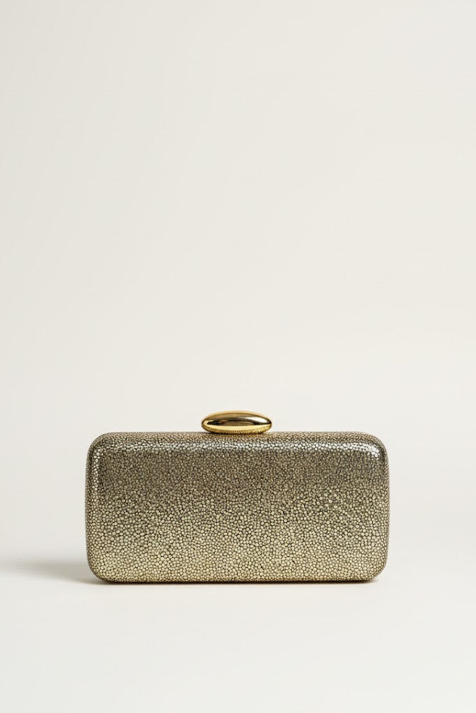 Gold clutch bag on a light beige background