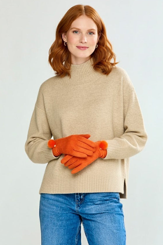 Woman wearing a brown turtleneck and orange gloves