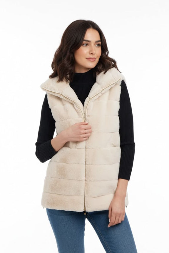 Woman wearing a cream faux fur vest