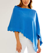 Woman in blue poncho with a scallop hemline