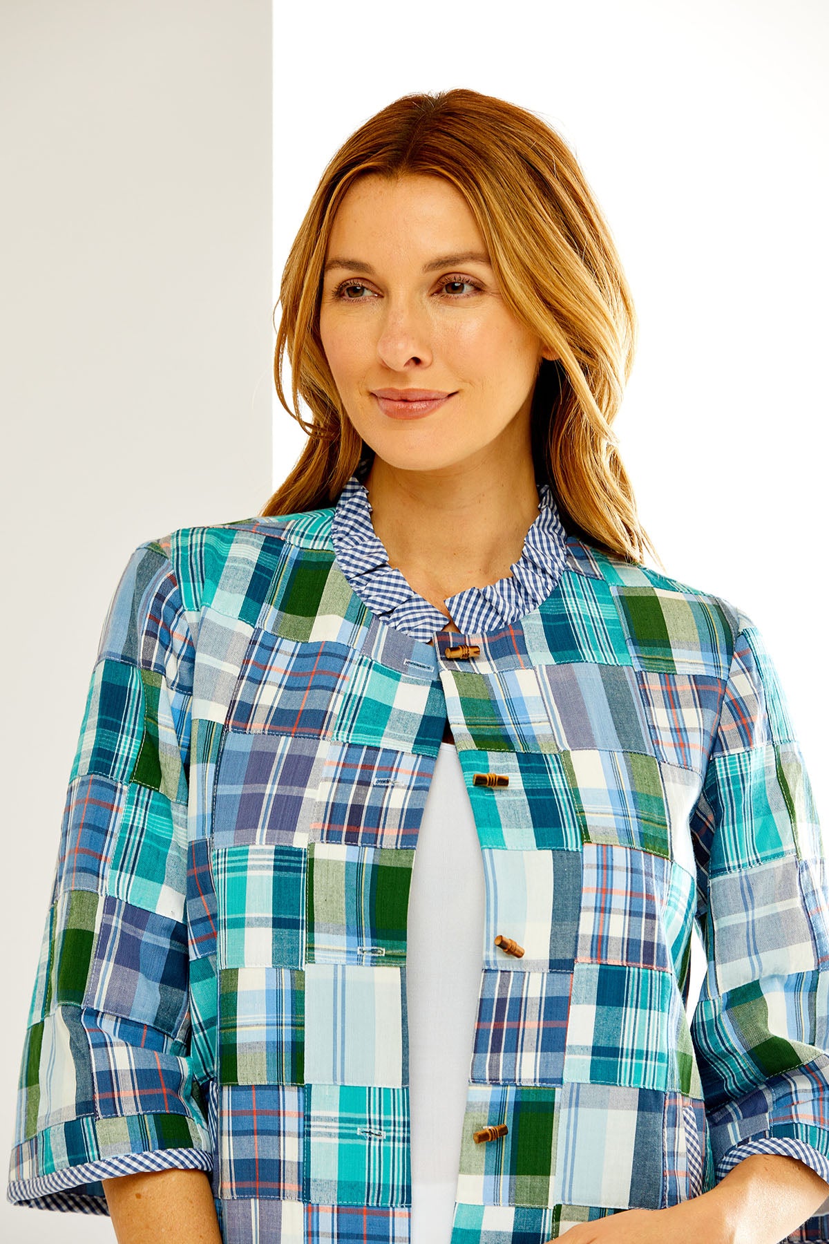 Woman in blue multi-colored madras jacket