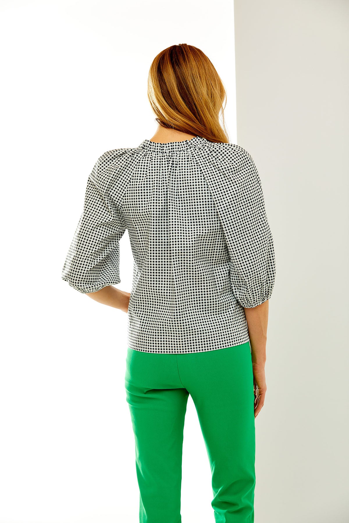 Woman in gingham trapeze blouse