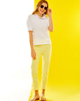 Woman in white tee and yellow pants