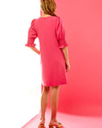 Woman in pink puff sleeve short dress