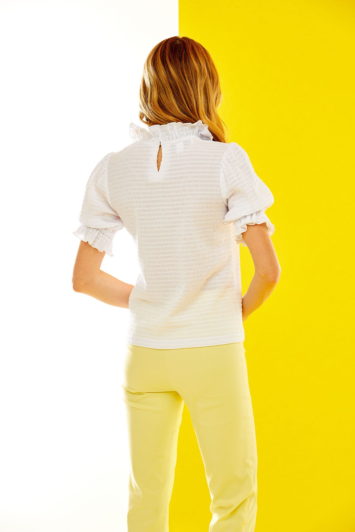 Back view of a woman in a white tee