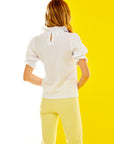 Back view of a woman in a white tee
