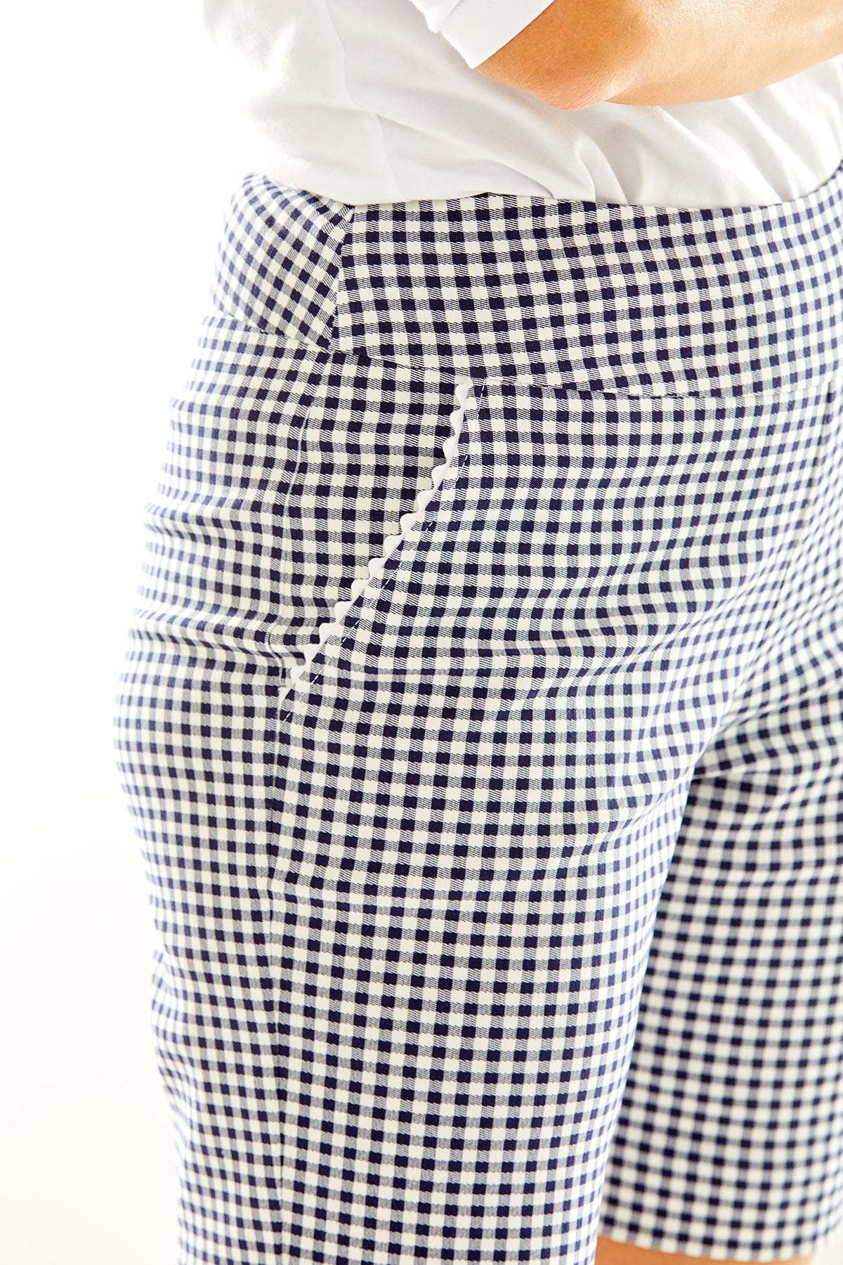 Woman in gingham golf shorts