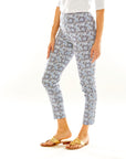 Woman wearing slim fitted pants in a blue floral print