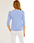 Woman in periwinkle knit tee with 3/4 length puff sleeves