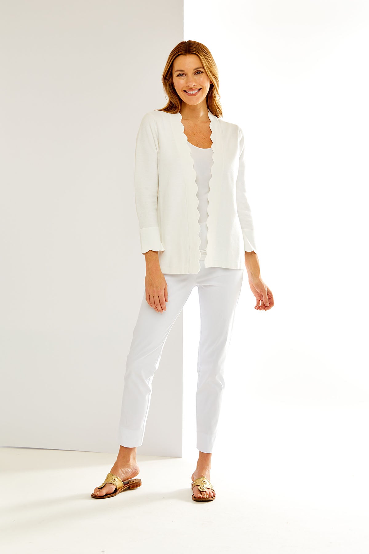 Woman in off-white scallop cardigan