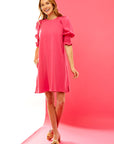 Woman in pink puff sleeve short dress